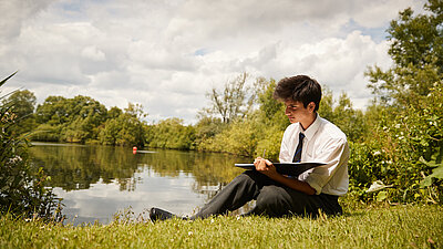 A boy sitting outside of a Summer Day