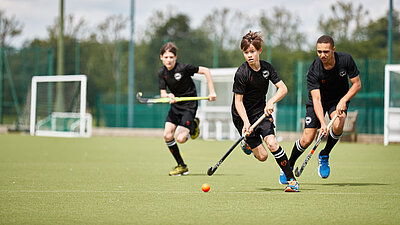 Three Hockey players in action