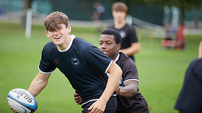 One Rugby player tackling another