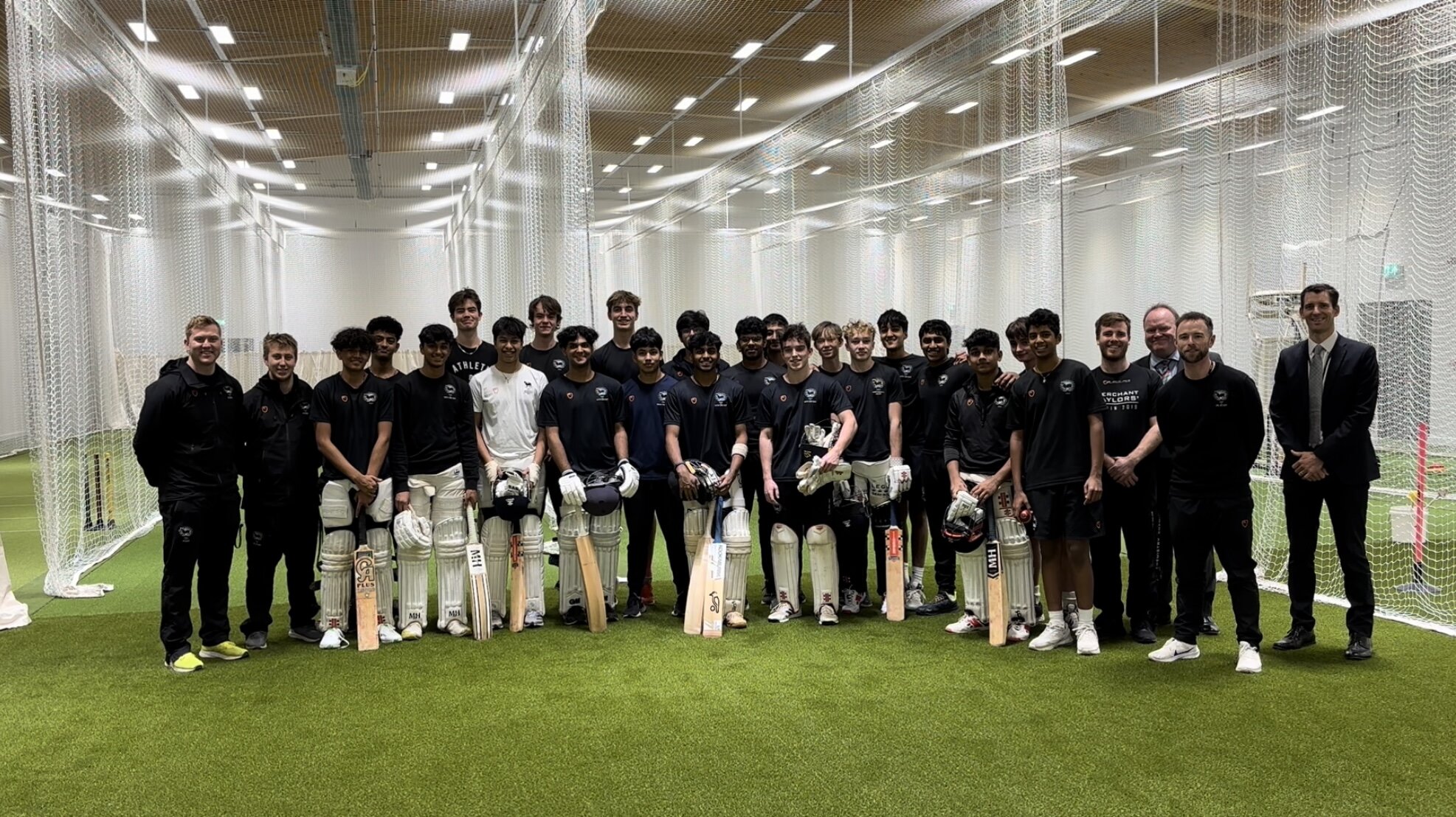 Cricketers pose for a group picture in a cricket training centre