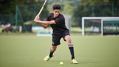 Hockey player striking a ball