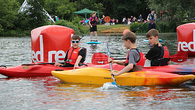 Boys in canoes on the lake