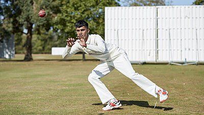 Cricketer catching a ball