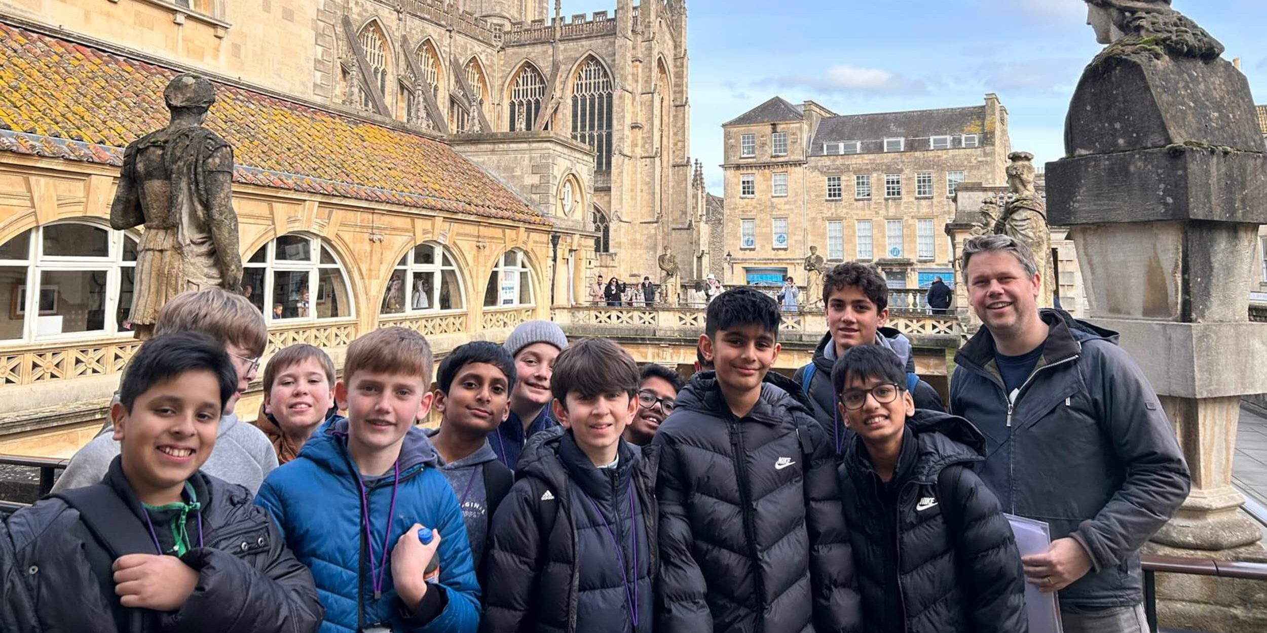 A group of year 7 boys in front of the roman baths and cathedral